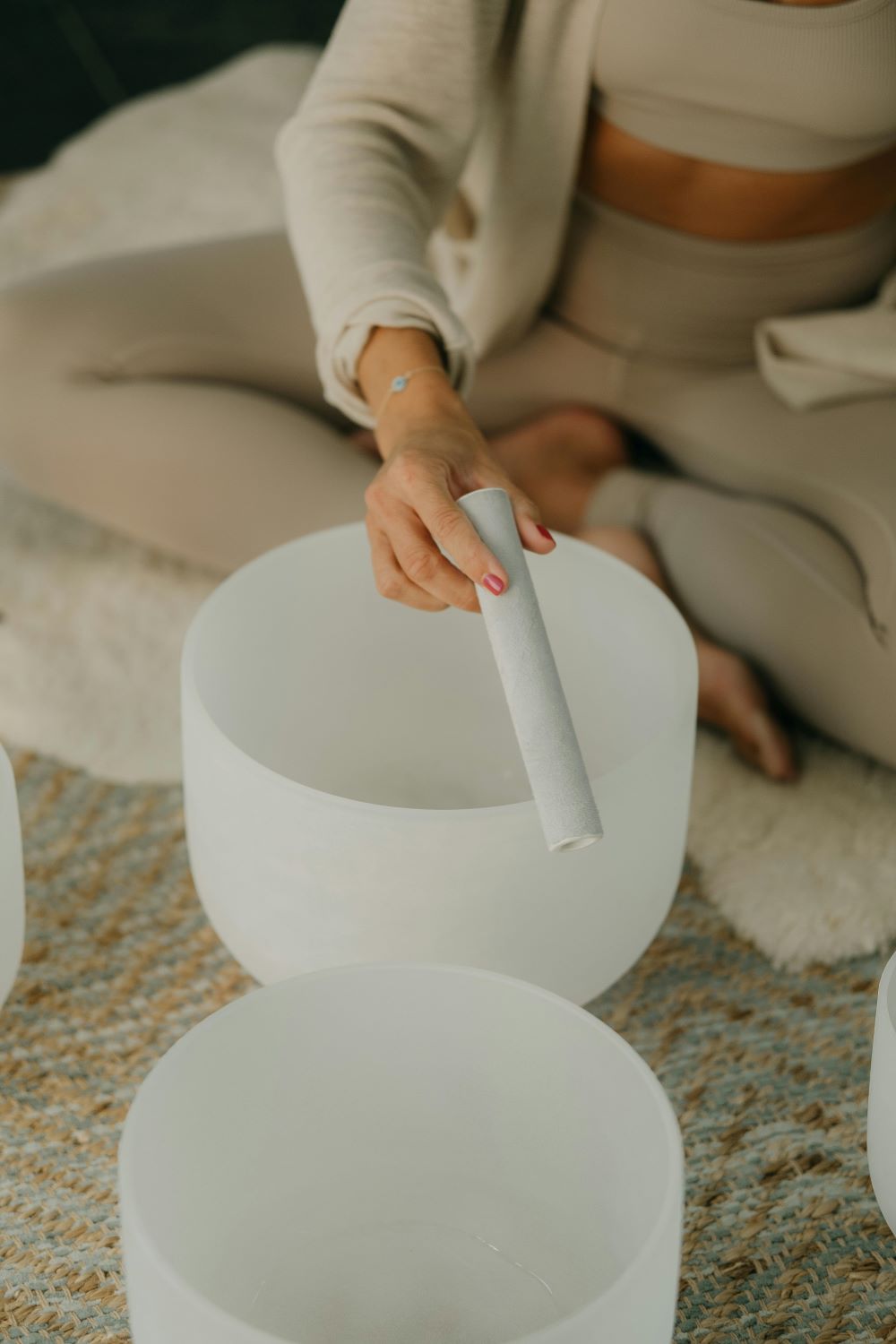 woman playing sound bowls